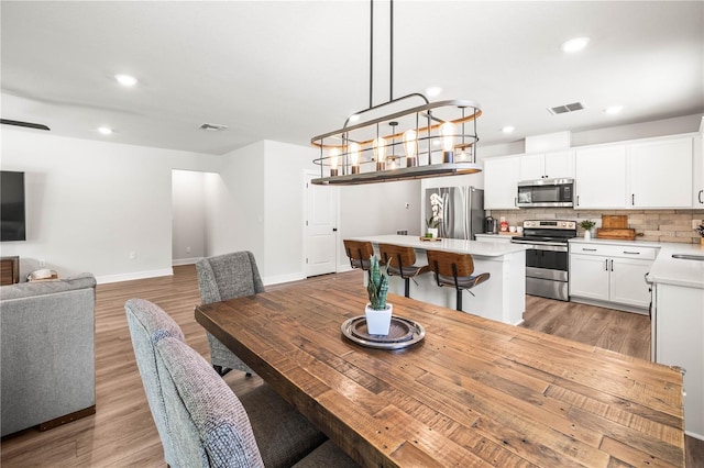 30273 Marquette Ave, Wesley Chapel, FL 33545 - dining room with light wood-style flooring, baseboards, and recessed lighting