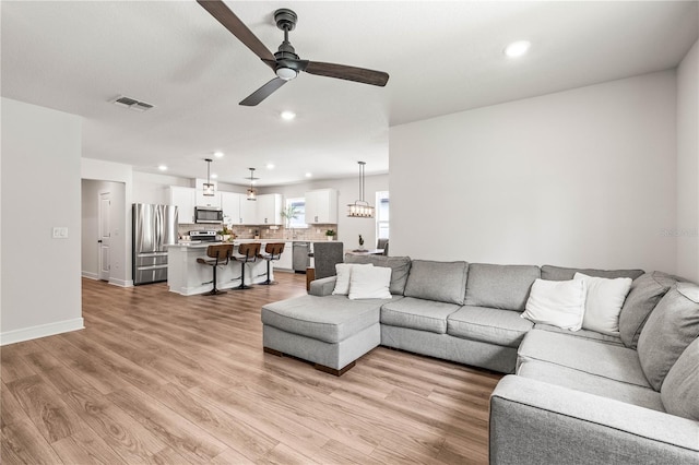 30273 Marquette Ave, Wesley Chapel, FL 33545 - living room featuring ceiling fan, recessed lighting, light wood-type flooring, and baseboards