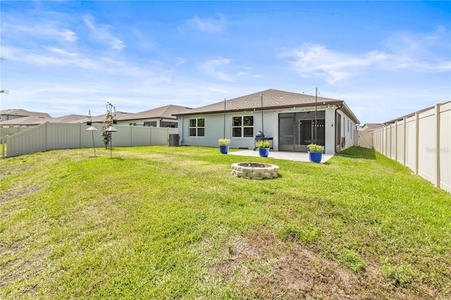 30273 Marquette Ave, Wesley Chapel, FL 33545 - back of property featuring an outdoor fire pit and a sunroom