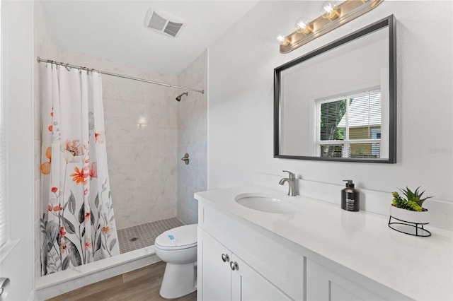 2911 N Jefferson St, Tampa, FL 33602 - full bath with vanity, toilet, a shower stall, and wood finished floors