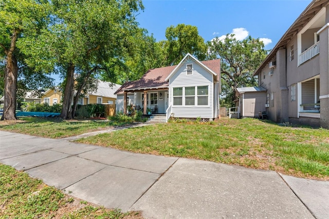 2911 N Jefferson St, Tampa, FL 33602 - bungalow-style house featuring covered porch and a front lawn