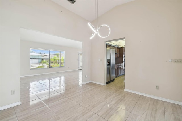 6322 Cocoa Ln, Apollo Beach, FL 33572 - unfurnished room featuring light tile patterned flooring, high vaulted ceiling, baseboards, and a chandelier