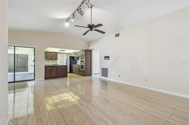 6322 Cocoa Ln, Apollo Beach, FL 33572 - unfurnished living room with lofted ceiling, track lighting, a ceiling fan, baseboards, and light tile patterned floors
