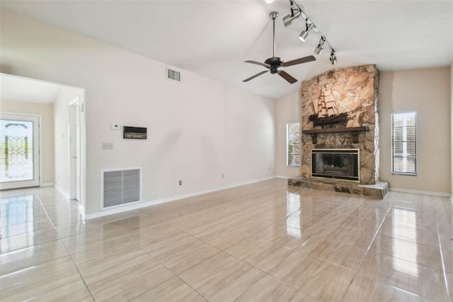 6322 Cocoa Ln, Apollo Beach, FL 33572 - unfurnished living room with light tile patterned floors, vaulted ceiling, ceiling fan, a fireplace, and baseboards
