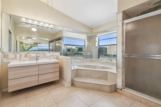 6322 Cocoa Ln, Apollo Beach, FL 33572 - full bathroom featuring vaulted ceiling, a stall shower, vanity, a garden tub, and tile patterned floors