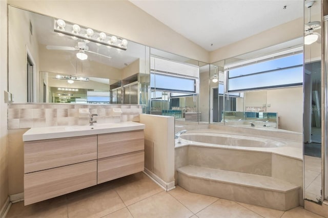 6322 Cocoa Ln, Apollo Beach, FL 33572 - bathroom with a garden tub, vanity, tile patterned flooring, vaulted ceiling, and ceiling fan