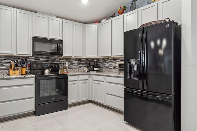 6555 Sparkling Way, Wesley Chapel, FL 33545 - kitchen featuring black appliances, tasteful backsplash, light tile patterned floors, light stone counters, and a textured ceiling