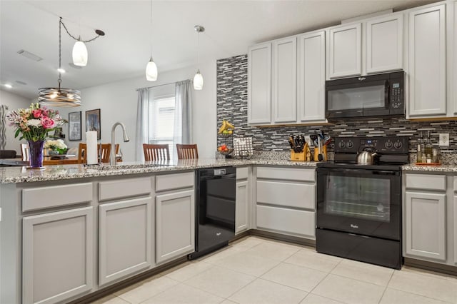 6555 Sparkling Way, Wesley Chapel, FL 33545 - kitchen featuring black appliances, a sink, backsplash, a peninsula, and light tile patterned floors