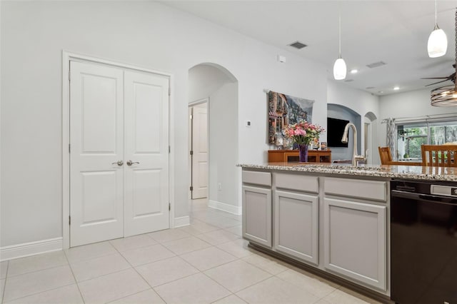 6555 Sparkling Way, Wesley Chapel, FL 33545 - kitchen with arched walkways, black dishwasher, light tile patterned floors, hanging light fixtures, and light stone countertops