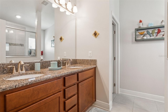 6555 Sparkling Way, Wesley Chapel, FL 33545 - full bathroom with double vanity, tiled shower, tile patterned floors, and baseboards