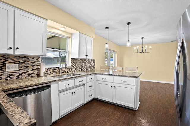 9780 Allen Rd, Lithia, FL 33547 - kitchen featuring stainless steel appliances, a sink, a peninsula, and dark wood-type flooring