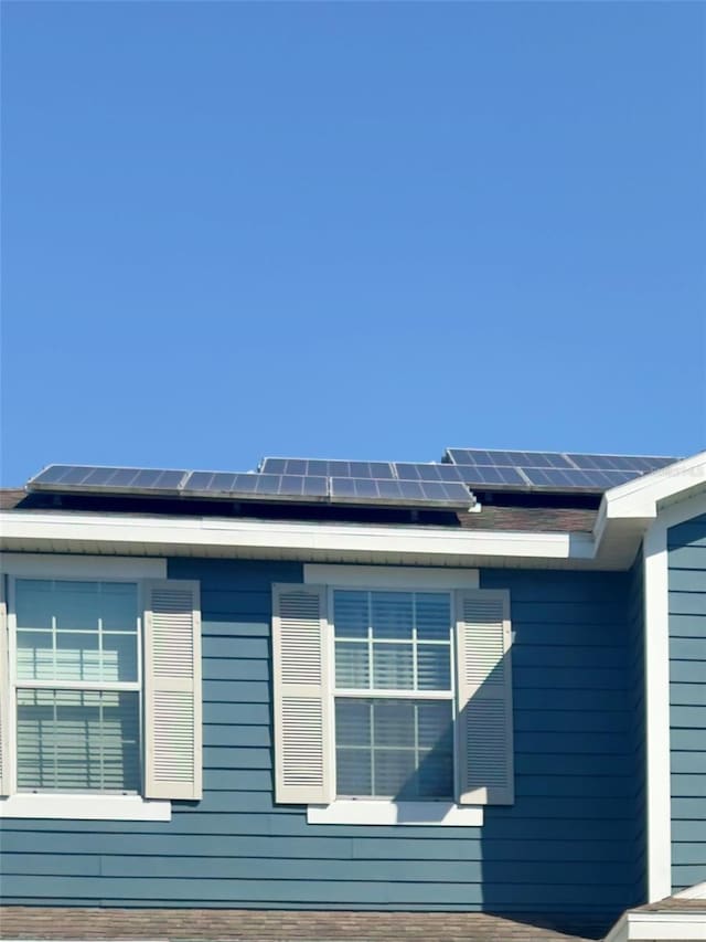 view of home's exterior with roof mounted solar panels