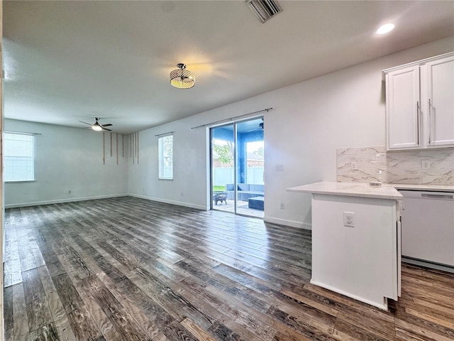 unfurnished living room with a ceiling fan, dark wood-style floors, and baseboards