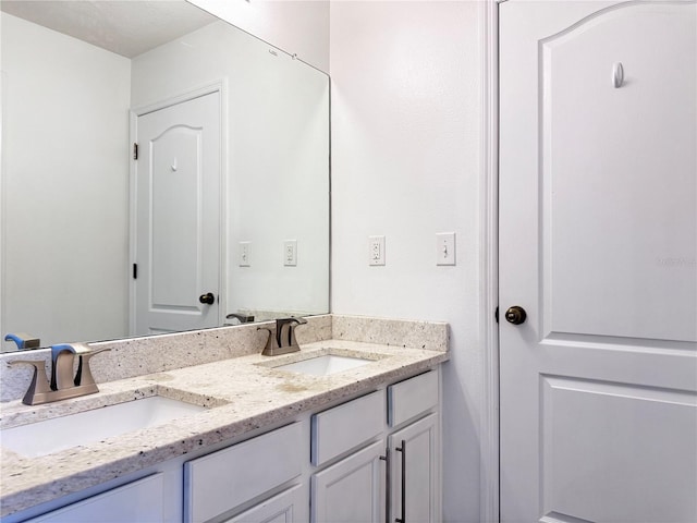 bathroom featuring double vanity