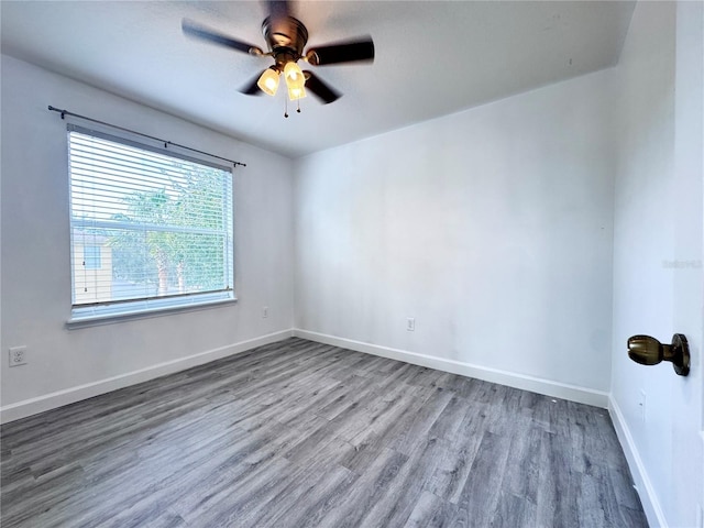 unfurnished room featuring wood finished floors, ceiling fan, and baseboards