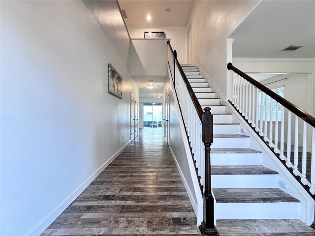 stairs featuring wood finished floors and baseboards