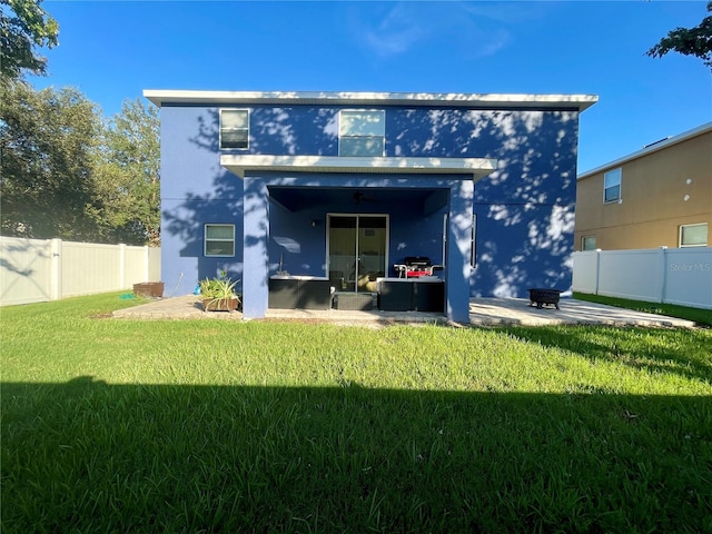 rear view of house featuring stucco siding and a patio