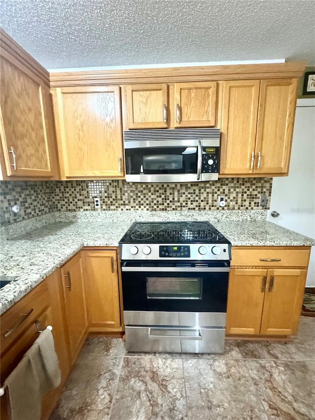 3181 Deltona Blvd, Spring Hill, FL 34606 - kitchen with stainless steel appliances, decorative backsplash, a textured ceiling, and light stone countertops