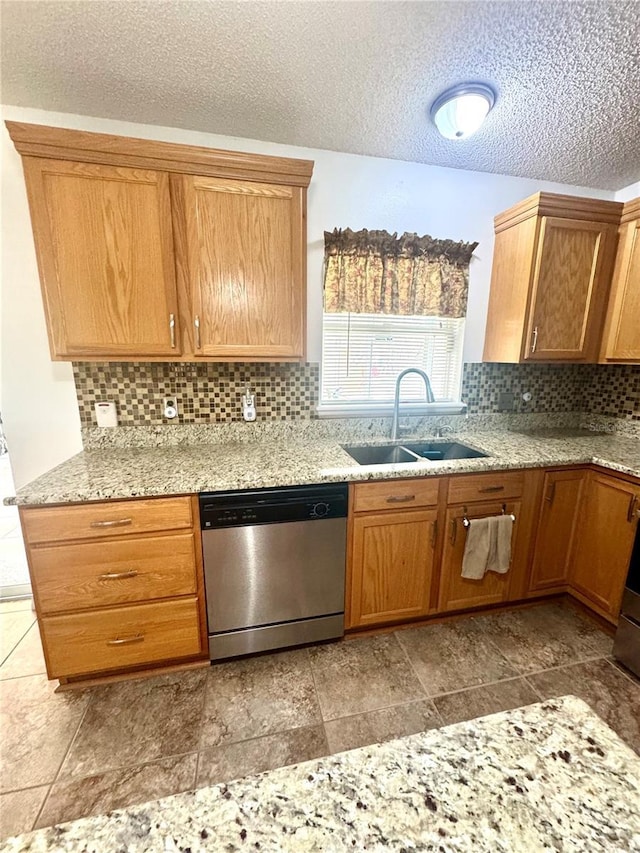 3181 Deltona Blvd, Spring Hill, FL 34606 - kitchen with dishwasher, a sink, tasteful backsplash, a textured ceiling, and light stone countertops