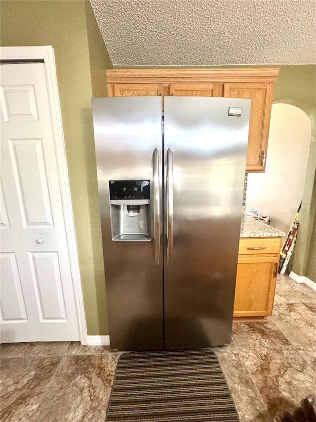 3181 Deltona Blvd, Spring Hill, FL 34606 - kitchen featuring stainless steel refrigerator with ice dispenser, baseboards, and a textured ceiling