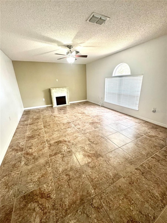 3181 Deltona Blvd, Spring Hill, FL 34606 - unfurnished living room featuring a ceiling fan, tile patterned flooring, a textured ceiling, a fireplace, and baseboards