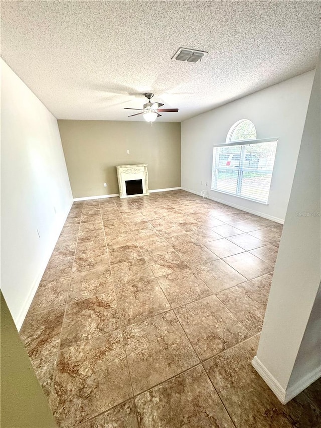 3181 Deltona Blvd, Spring Hill, FL 34606 - unfurnished living room featuring a ceiling fan, tile patterned floors, a fireplace, a textured ceiling, and baseboards