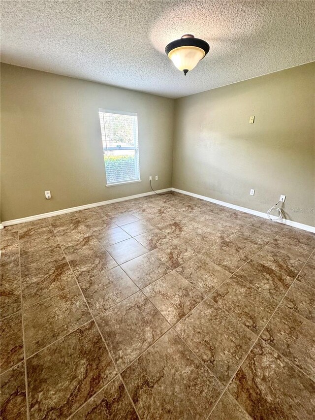 3181 Deltona Blvd, Spring Hill, FL 34606 - unfurnished room featuring a textured ceiling, tile patterned floors, and baseboards