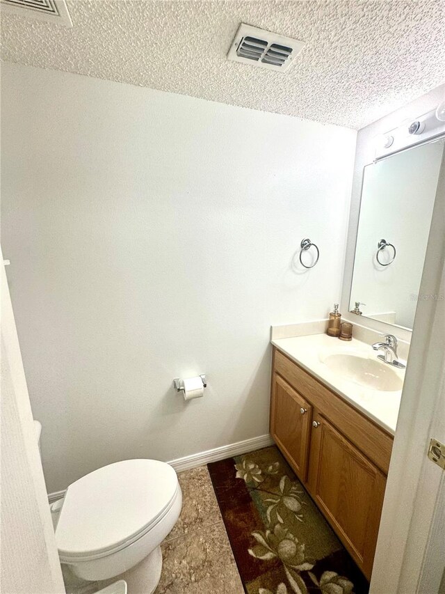 3181 Deltona Blvd, Spring Hill, FL 34606 - bathroom with vanity, toilet, a textured ceiling, and baseboards
