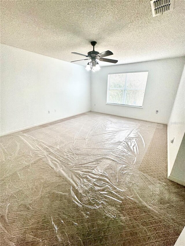 3181 Deltona Blvd, Spring Hill, FL 34606 - spare room featuring a ceiling fan, carpet flooring, and a textured ceiling