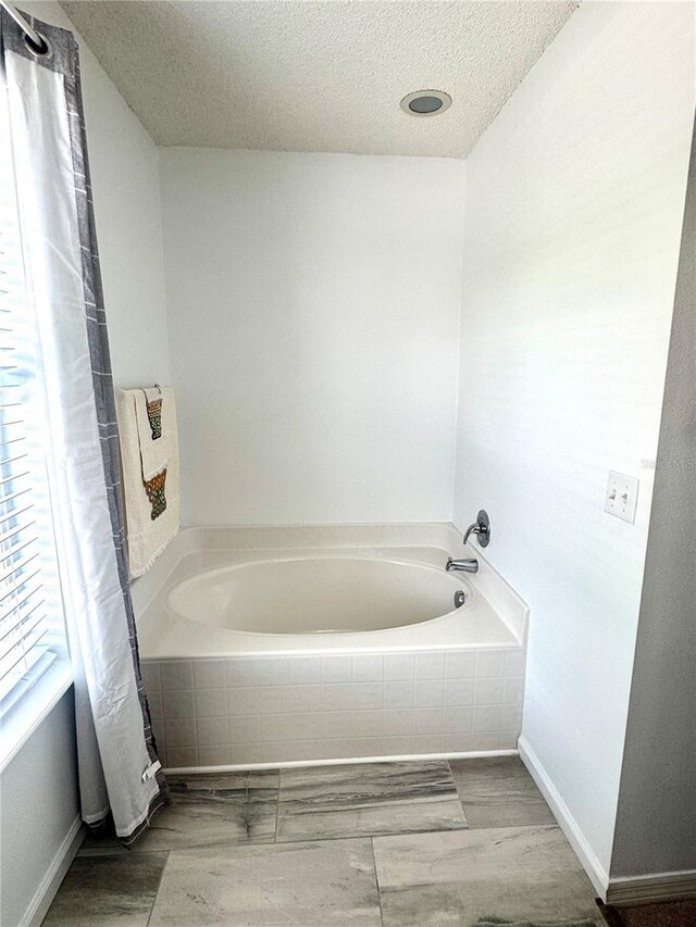3181 Deltona Blvd, Spring Hill, FL 34606 - full bathroom featuring a bath and a textured ceiling