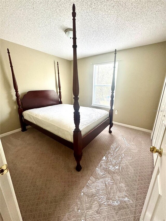 3181 Deltona Blvd, Spring Hill, FL 34606 - carpeted bedroom featuring baseboards and a textured ceiling