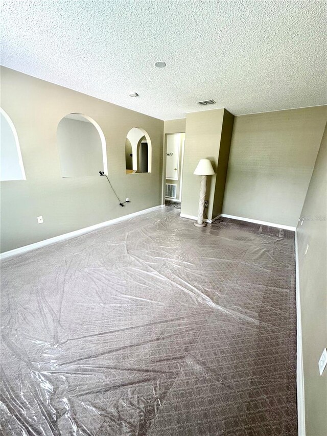 3181 Deltona Blvd, Spring Hill, FL 34606 - empty room featuring baseboards, carpet, and a textured ceiling