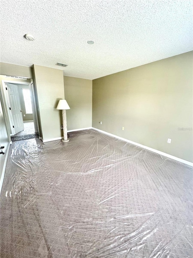 3181 Deltona Blvd, Spring Hill, FL 34606 - carpeted spare room with baseboards and a textured ceiling