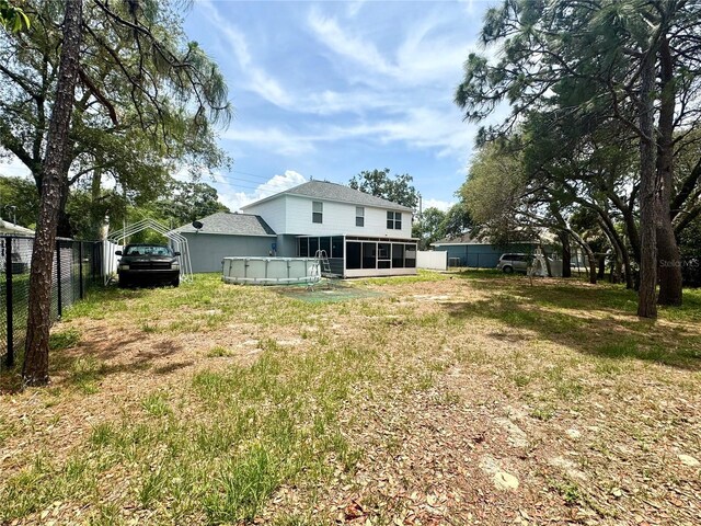 3181 Deltona Blvd, Spring Hill, FL 34606 - back of property with a sunroom