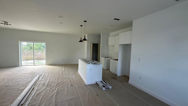 12167 Florence Ave, Port Charlotte, FL 33981 - kitchen featuring open floor plan, white cabinets, a center island, and hanging light fixtures