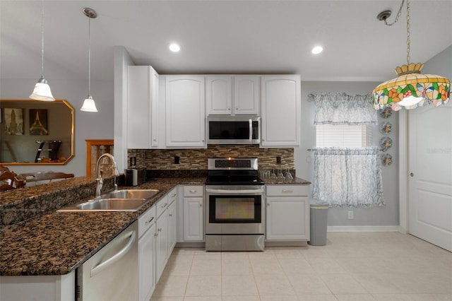 6303 Gentle Ben Cir, Wesley Chapel, FL 33544 - kitchen with appliances with stainless steel finishes, a sink, decorative backsplash, dark stone countertops, and recessed lighting