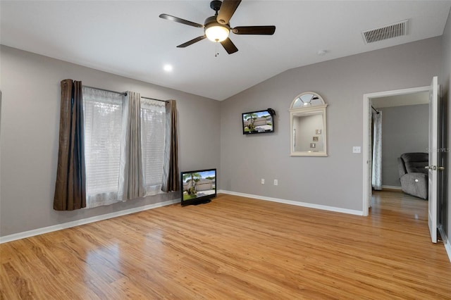6303 Gentle Ben Cir, Wesley Chapel, FL 33544 - spare room featuring light wood-type flooring, vaulted ceiling, a ceiling fan, and baseboards