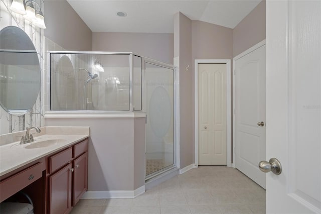 6303 Gentle Ben Cir, Wesley Chapel, FL 33544 - full bath with vanity, a stall shower, tile patterned flooring, and baseboards