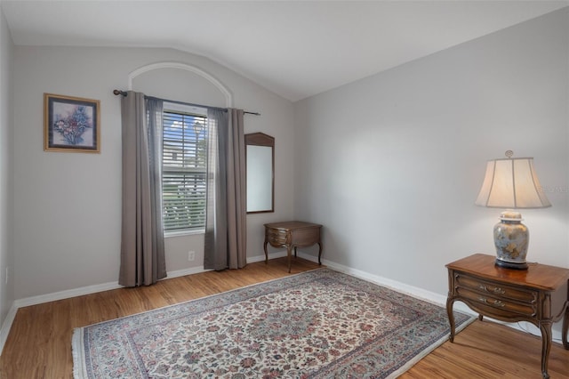 6303 Gentle Ben Cir, Wesley Chapel, FL 33544 - living area featuring wood finished floors, lofted ceiling, and baseboards