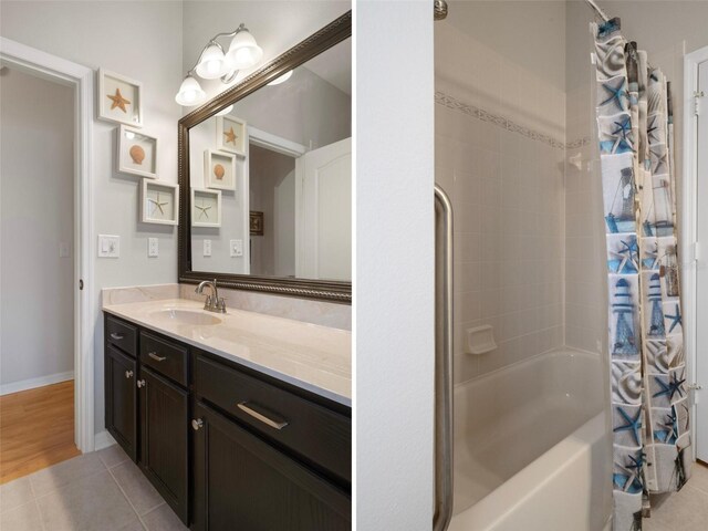 6303 Gentle Ben Cir, Wesley Chapel, FL 33544 - full bath with shower / bathtub combination with curtain, vanity, tile patterned flooring, and baseboards