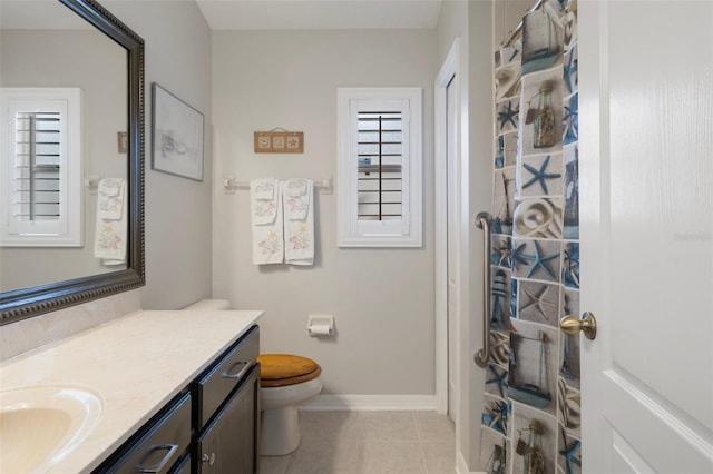 6303 Gentle Ben Cir, Wesley Chapel, FL 33544 - bathroom featuring vanity, toilet, tile patterned flooring, baseboards, and curtained shower