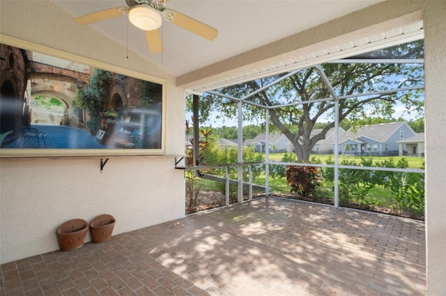 6303 Gentle Ben Cir, Wesley Chapel, FL 33544 - unfurnished sunroom with ceiling fan and a residential view