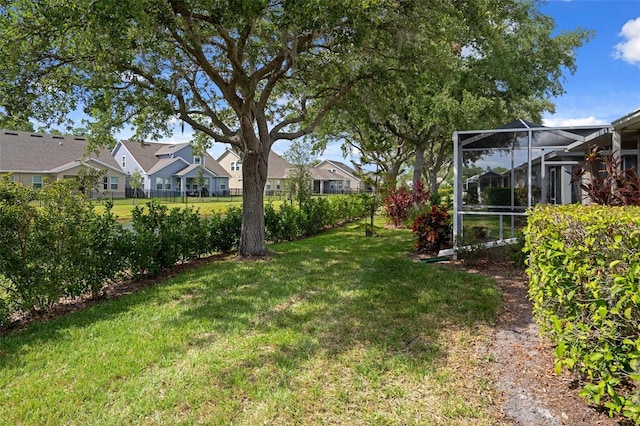 6303 Gentle Ben Cir, Wesley Chapel, FL 33544 - view of grassy yard with a residential view and a lanai