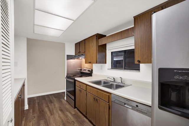 8630 Cattail Dr Unit 8630, Temple Terrace, FL 33637 - kitchen with stainless steel appliances, a sink, light countertops, dark wood-type flooring, and under cabinet range hood