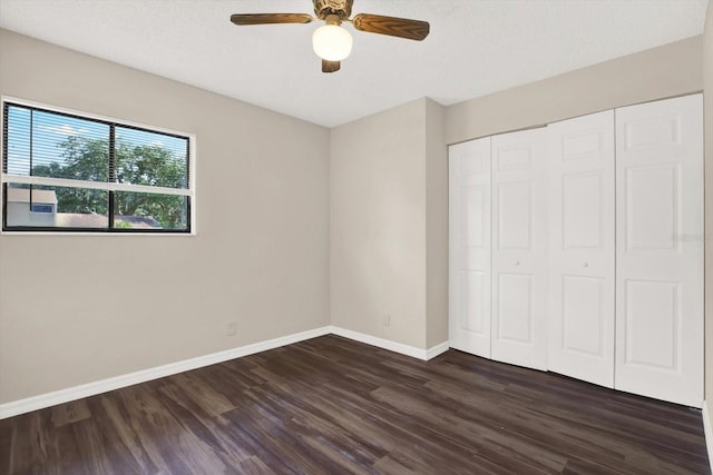8630 Cattail Dr Unit 8630, Temple Terrace, FL 33637 - unfurnished bedroom featuring dark wood-style flooring, baseboards, a closet, and ceiling fan