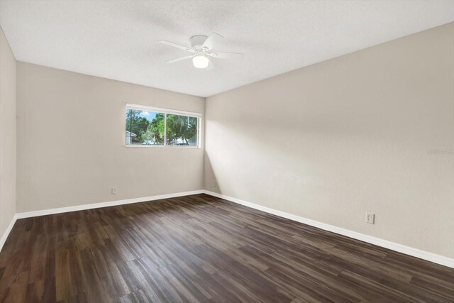 8630 Cattail Dr Unit 8630, Temple Terrace, FL 33637 - spare room with a ceiling fan, baseboards, dark wood finished floors, and a textured ceiling