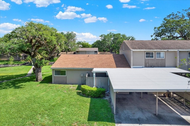 8630 Cattail Dr Unit 8630, Temple Terrace, FL 33637 - back of house featuring a yard and covered parking