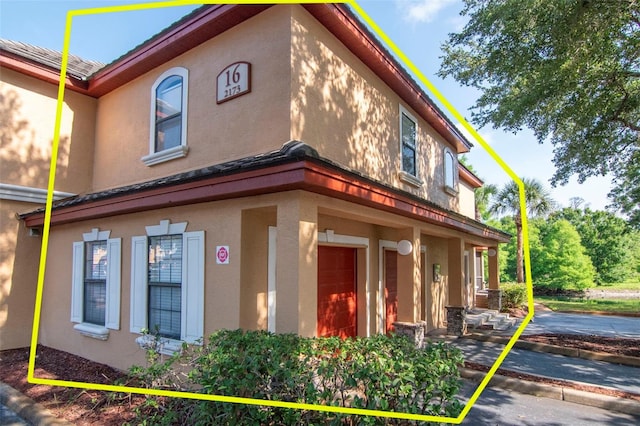 2173 Tuscany Trce Unit 8, Palm Harbor, FL 34683 - view of side of property with stucco siding
