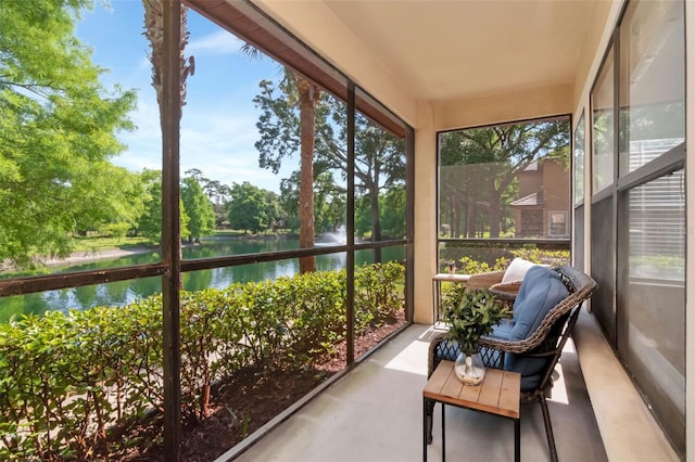 2173 Tuscany Trce Unit 8, Palm Harbor, FL 34683 - sunroom featuring a water view, view of wooded area, and plenty of natural light