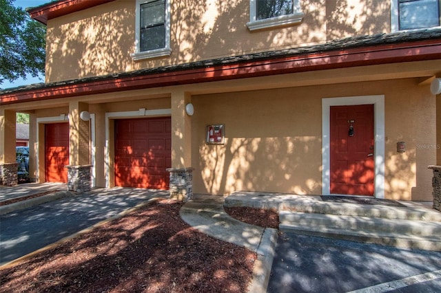 2173 Tuscany Trce Unit 8, Palm Harbor, FL 34683 - view of front facade featuring stucco siding, concrete driveway, and an attached garage